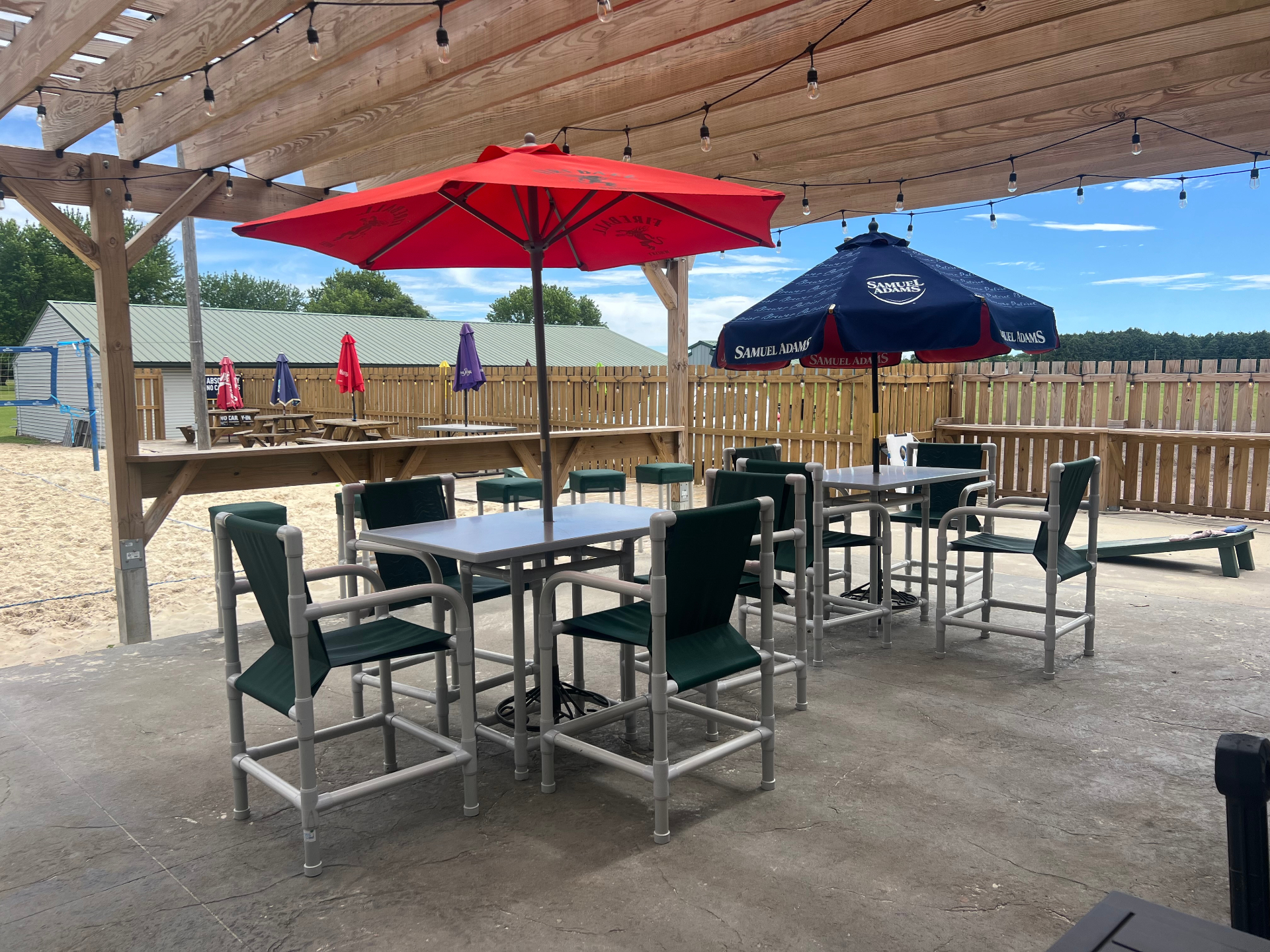 Wraparound deck with umbrellas overlooking the sand court