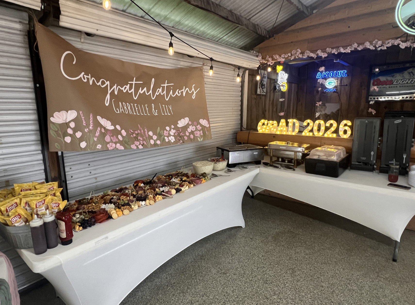 The Party Shed decorated for a celebration with a Congratulations banner and buffet setup