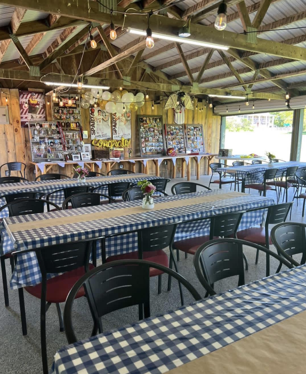 The Party Shed decorated with Sparta sports posters and gingham tablecloths