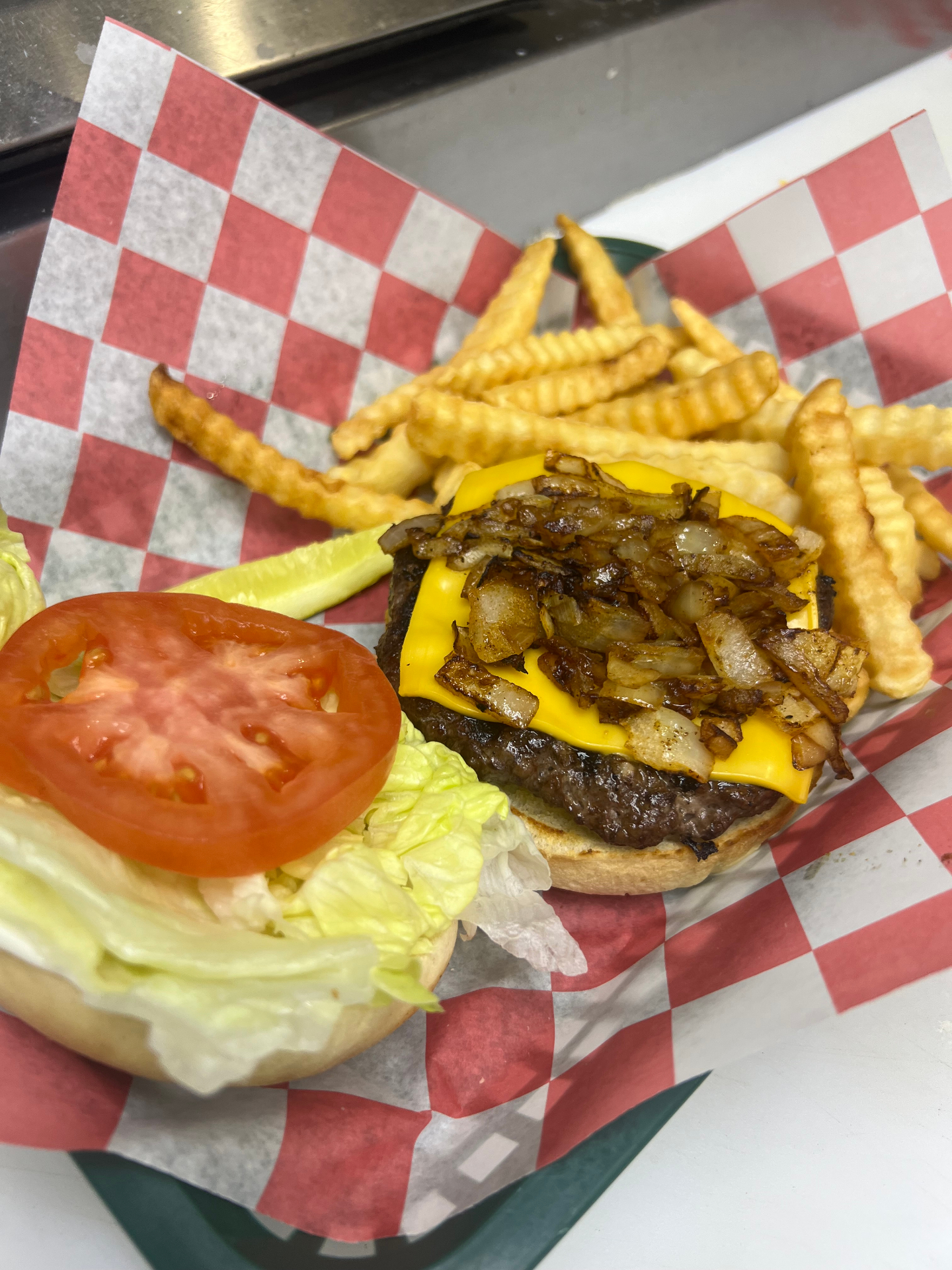 Hand-pattied cheeseburger with grilled onions and crinkle-cut fries